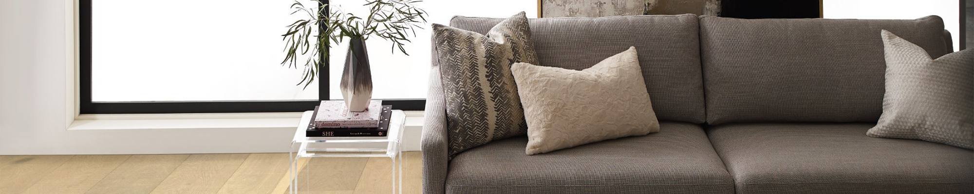 grey couch and side table in front of window